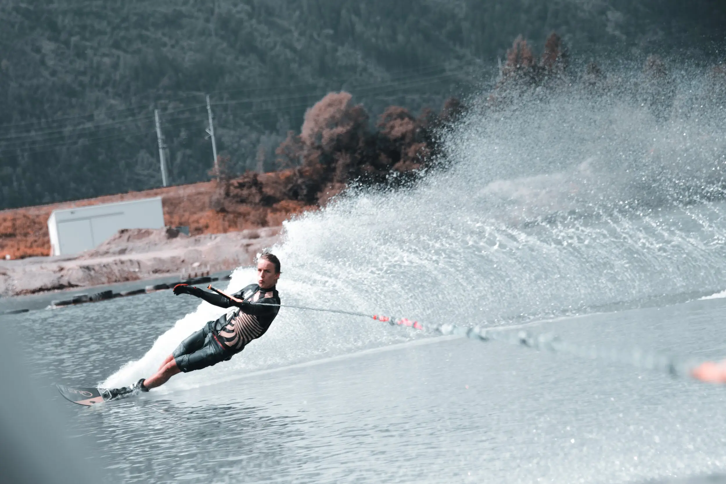 A slalom skier leaning hard into a turn on the lake
