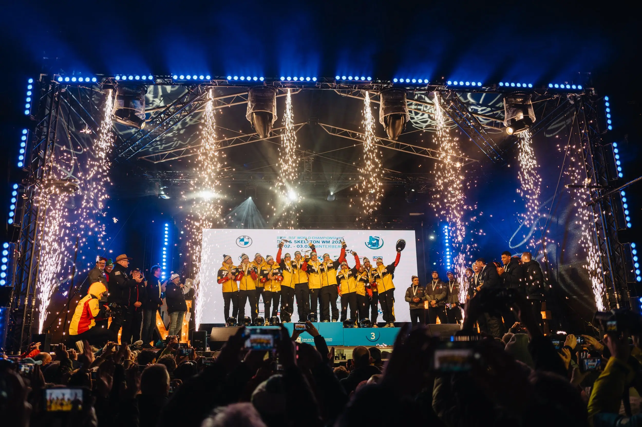 Medal ceremony on the stage with confetti falling over the teams