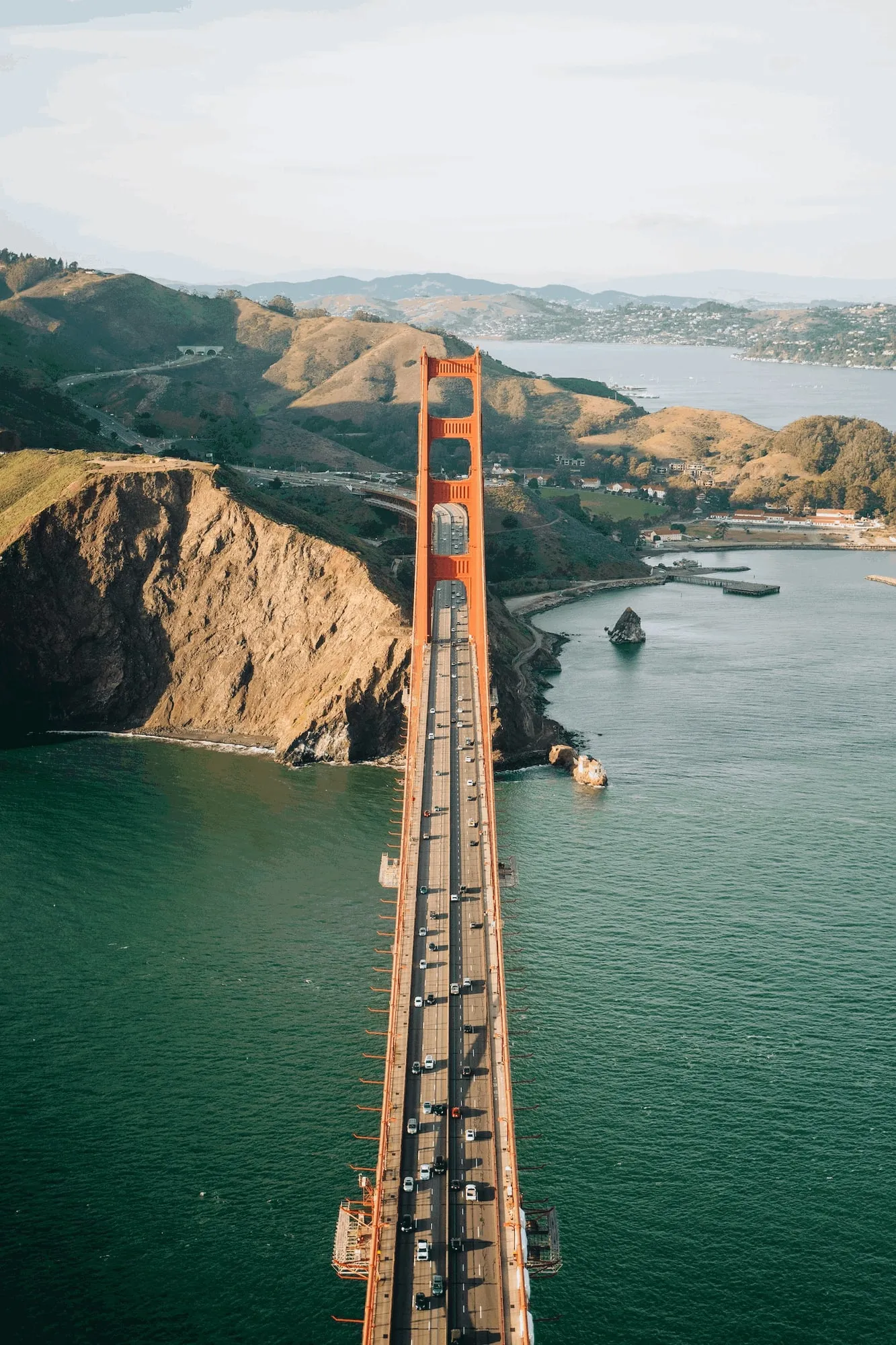 The Golden Gate Bridge from the air, traffic on the deck and the Marin Headlands behind