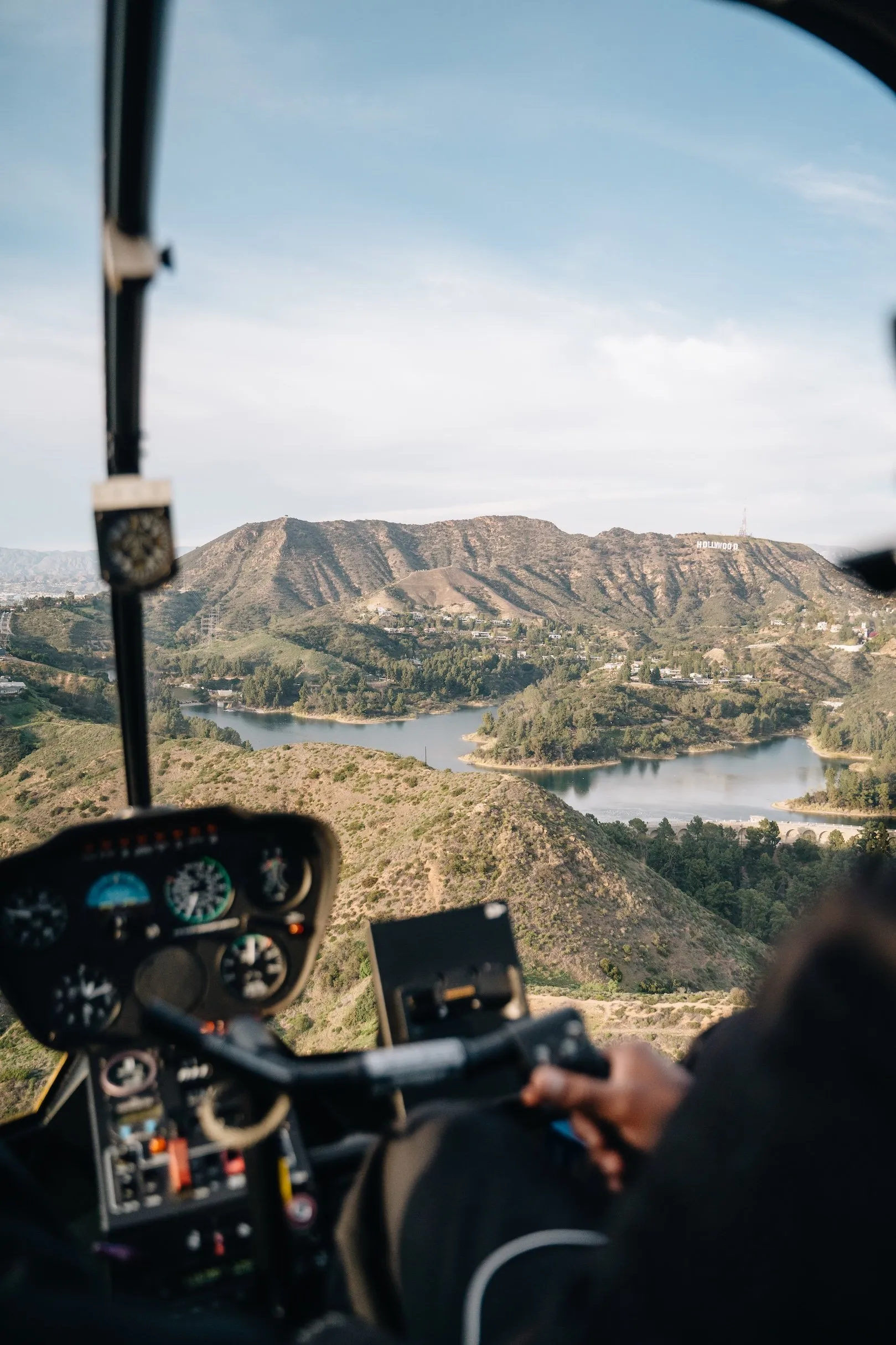 Looking out of a helicopter cockpit over the hills of Los Angeles